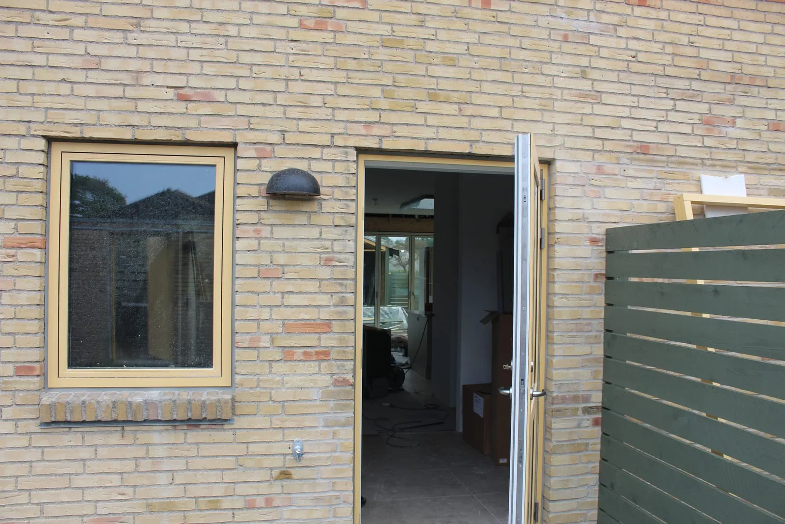 Dør og vindue i gult murværk med nye fuger